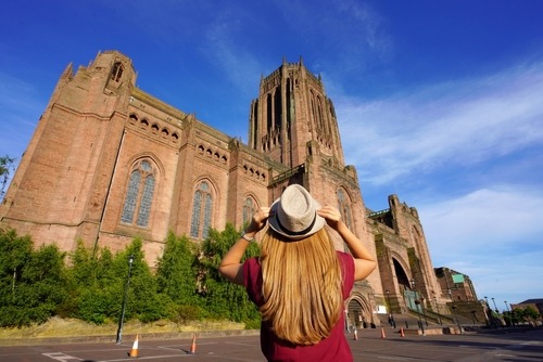 Picture of a girl wearing a hat in front of the Liverpool Cathedral -fun things to do in liverpool